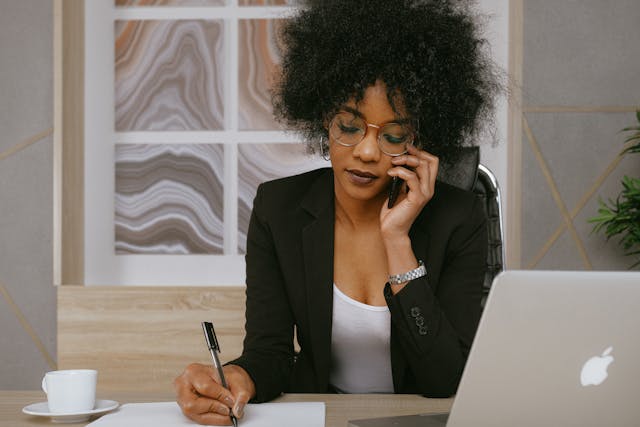 a property manager speaking on the phone while taking notes