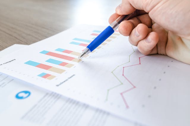 a blue pen pointing to a data point on a graph