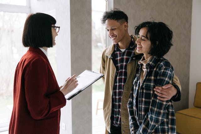 a property manager speaking with two prospective tenants