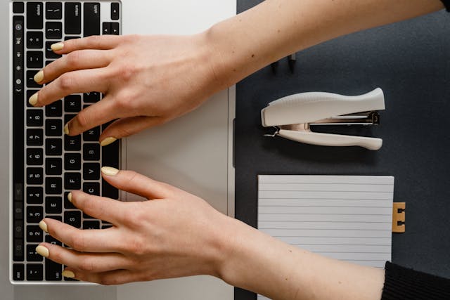 hands typing on a keyboard