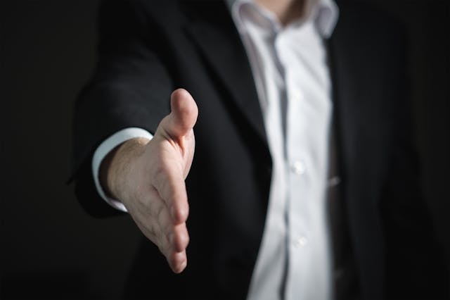 a person extending their hand for a handshake