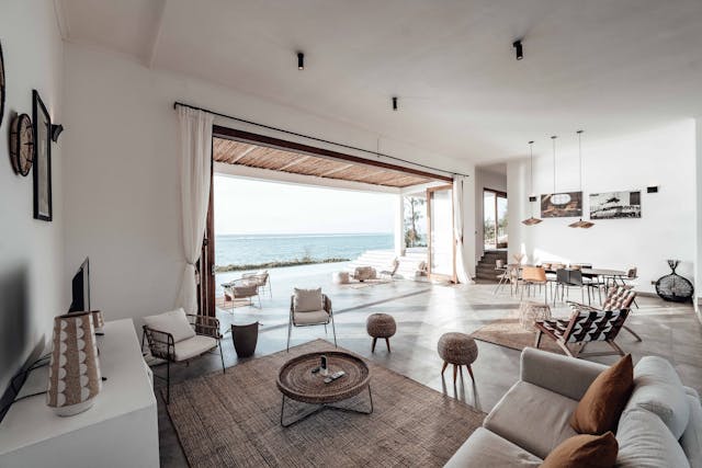 a white living area with warm tone pillows and carpets