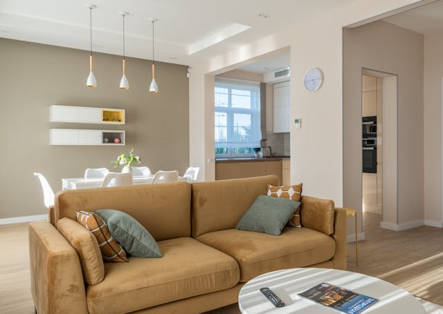 a beige and white open concept living and dinning room