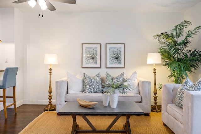 a living room with a tow-seater linen couch and matching arm chair