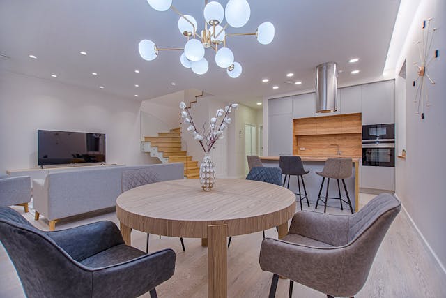 an open concept living space with blue and light wood tones