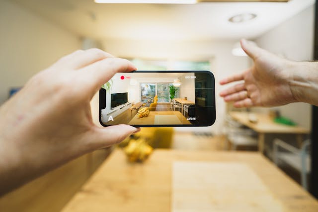 person talking a photo on their phone of a room