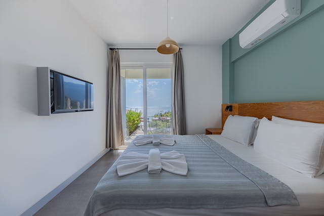 a bedroom that leads to a small outdoor patio