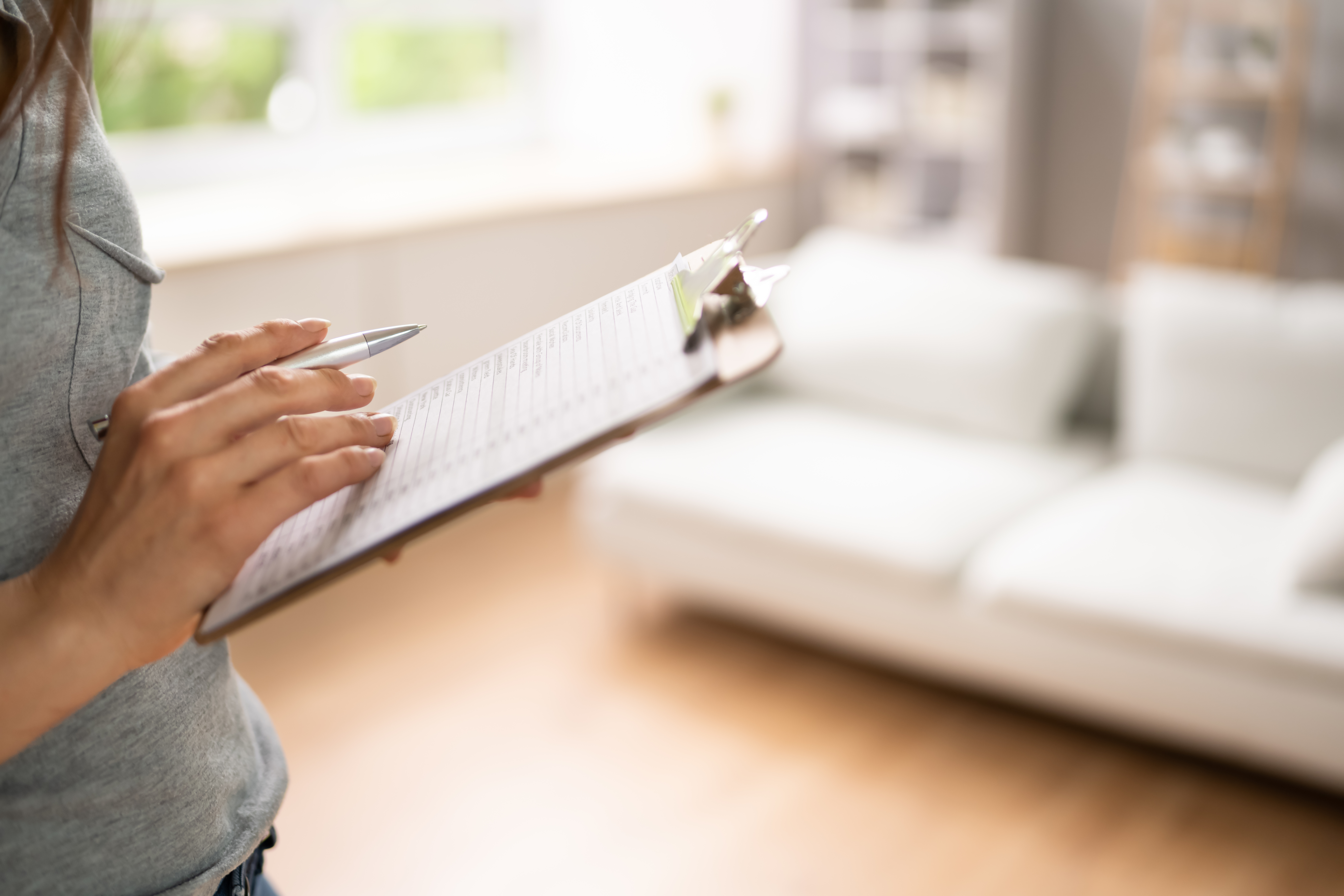 a person holding a clipboard with a checklist