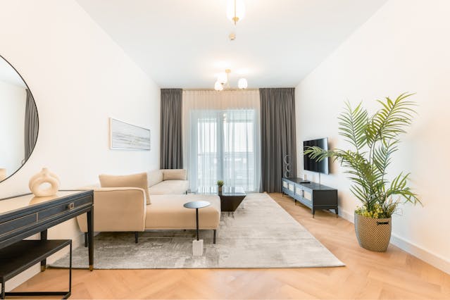 white and beige living room with a large couch and area rug